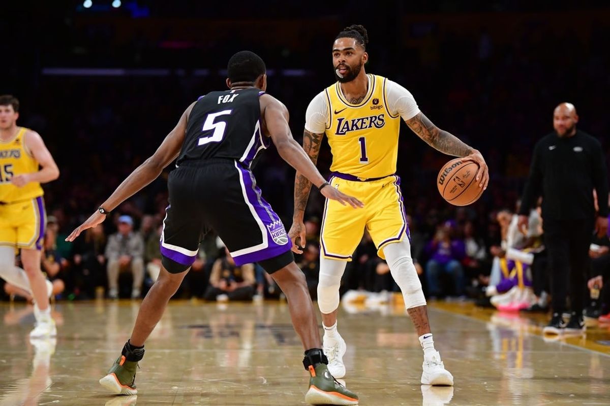 Mar 6, 2024; Los Angeles, California, USA; Los Angeles Lakers guard D'Angelo Russell (1) controls the ball against Sacramento Kings guard De'Aaron Fox (5) during the second half at Crypto.com Arena.