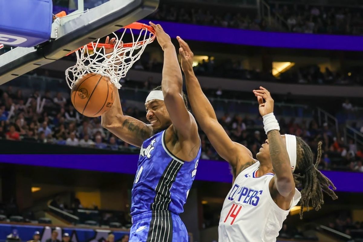 Mar 29, 2024; Orlando, Florida, USA; Orlando Magic center Wendell Carter Jr. (34) dunks in front of LA Clippers guard Terance Mann (14) during the second quarter at KIA Center.