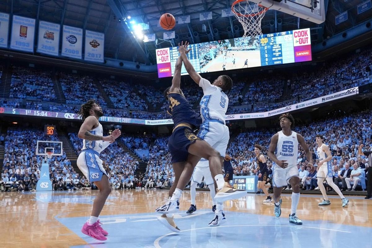Mar 5, 2024; Chapel Hill, North Carolina, USA; Notre Dame Fighting Irish forward Kebba Njie (14) has his shot blocked by North Carolina Tar Heels forward Armando Bacot (5) during the first half at Dean E. Smith Center.