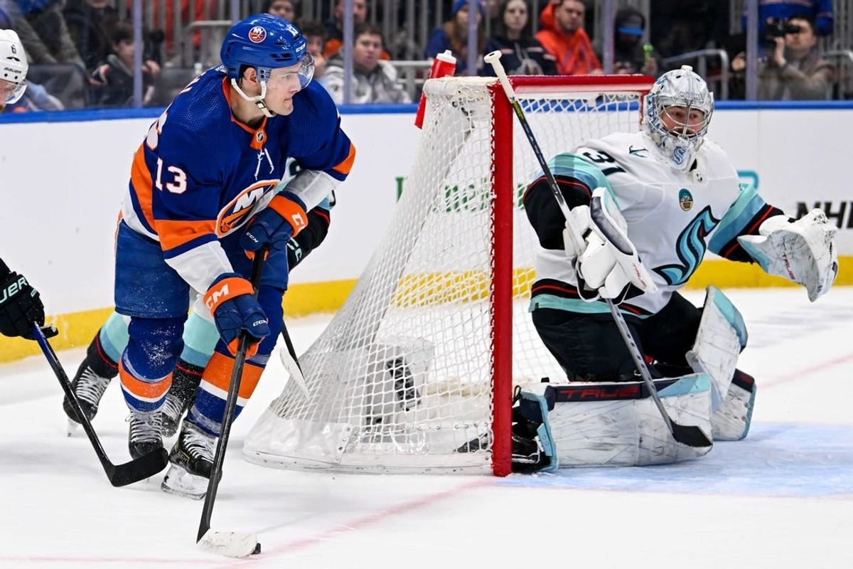 Feb 13, 2024; Elmont, New York, USA; New York Islanders center Mathew Barzal (13) attempts. A pass behind Seattle Kraken goaltender Philipp Grubauer (31) during the second period at UBS Arena.