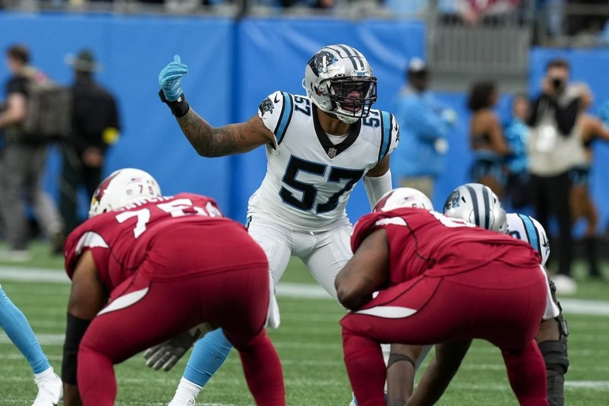 Oct 2, 2022; Charlotte, North Carolina, USA; Carolina Panthers linebacker Damien Wilson (57) motions to his teammates against the Arizona Cardinals during the second quarter at Bank of America Stadium.