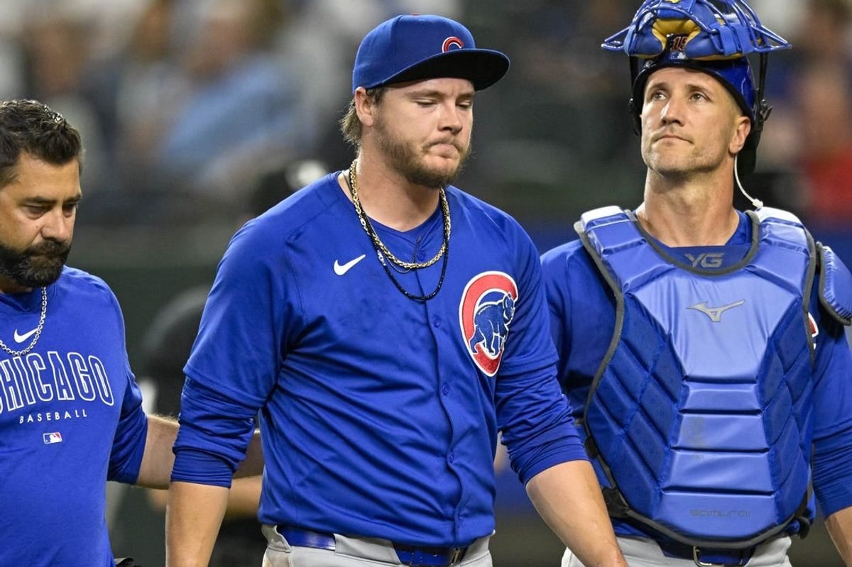 Mar 31, 2024; Arlington, Texas, USA; Chicago Cubs starting pitcher Justin Steele (35) and catcher Yan Gomes (15) walk off the field after Steele suffers an injury during the fifth inning against the Texas Rangers at Globe Life Field.