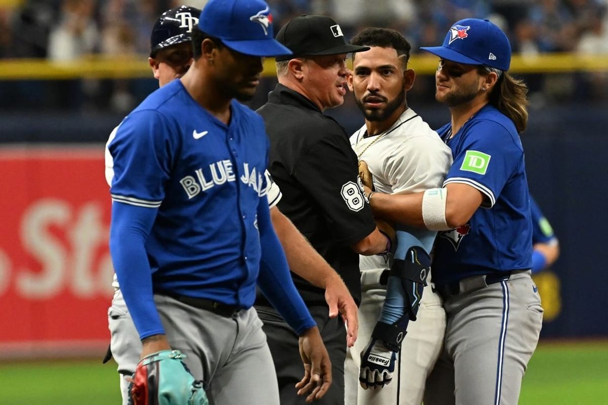 Mar 30, 2024; St. Petersburg, Florida, USA; Tampa Bay Rays shortstop Jose Caballero (7) stares at Toronto Blue Jays relief pitcher Genesis Cabrera (92) after they collide in the seventh inning of the game  at Tropicana Field.