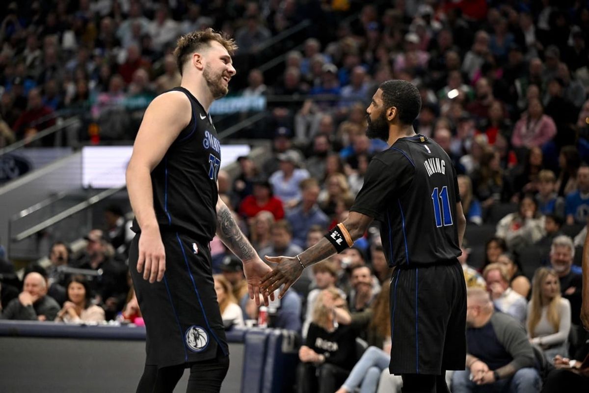 Feb 14, 2024; Dallas, Texas, USA; Dallas Mavericks guard Luka Doncic (77) and guard Kyrie Irving (11) celebrate during the second half against the San Antonio Spurs at the American Airlines Center.
