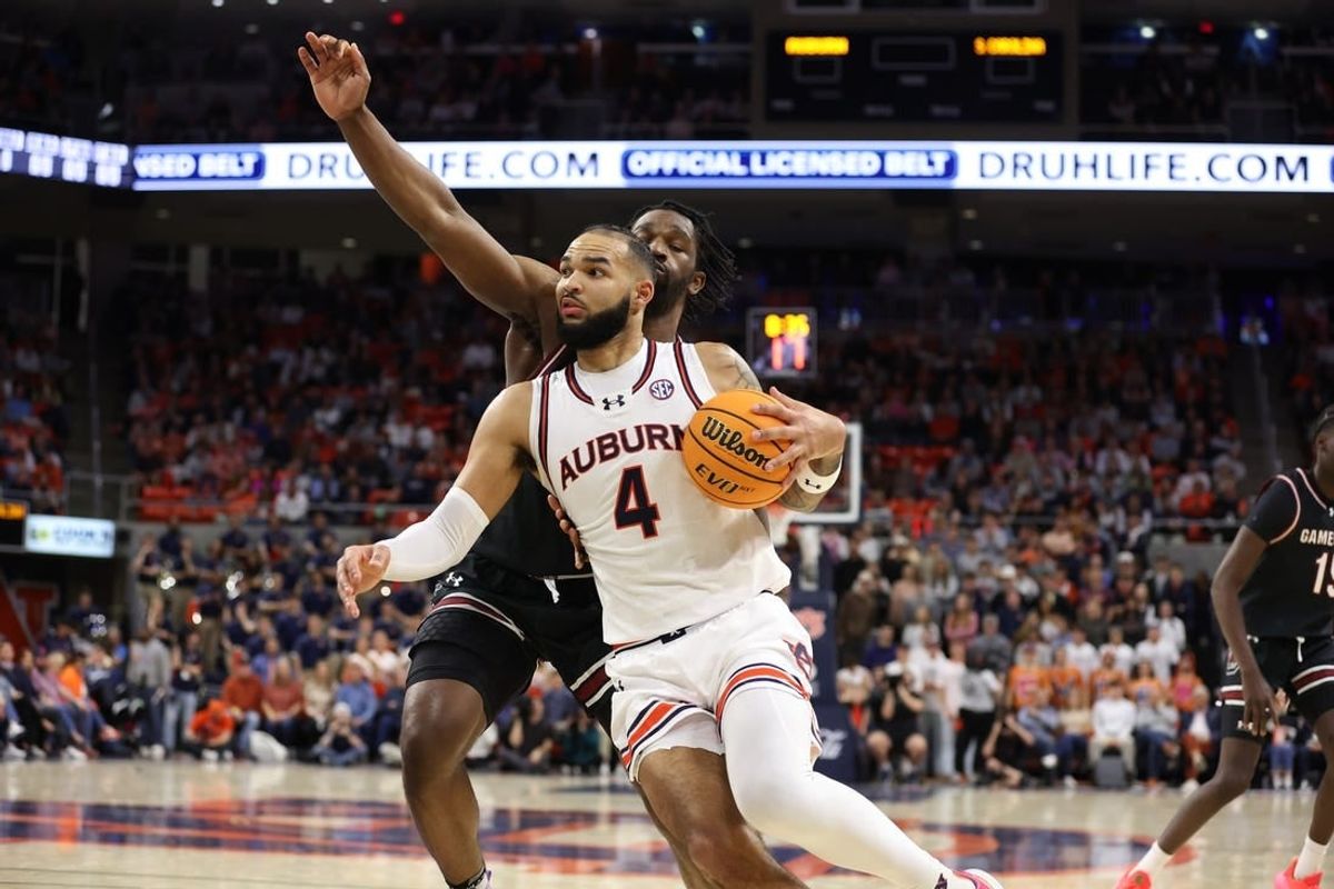 Feb 14, 2024; Auburn, Alabama, USA; Auburn Tigers forward Johni Broome (4) gets past South Carolina Gamecocks forward Josh Gray (33) for a shot during the second half at Neville Arena.