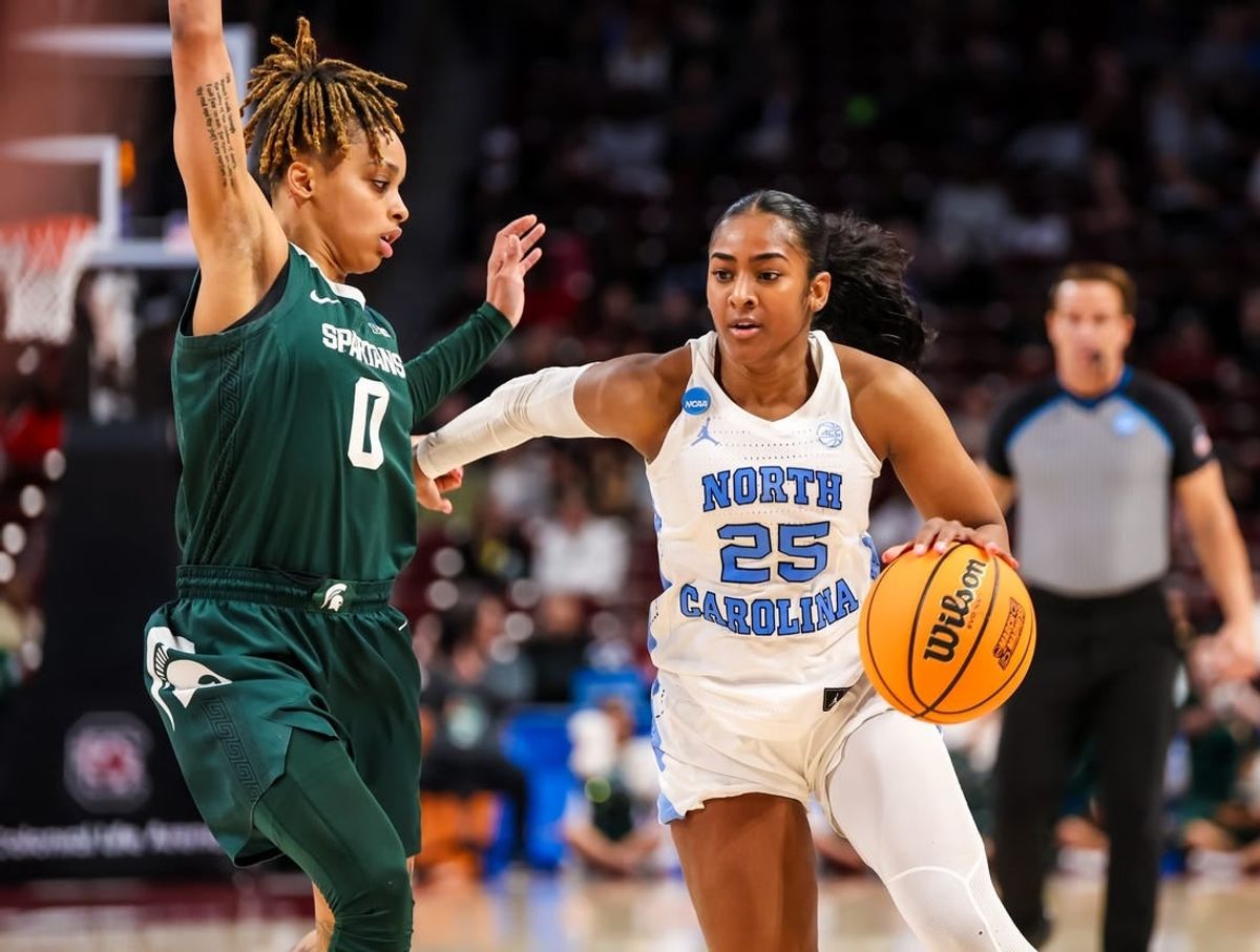Mar 22, 2024; Columbia, SC, USA; North Carolina Tar Heels guard Deja Kelly (25) drives around Michigan State Spartans guard DeeDee Hagemann (0) in the second half at Colonial Life Arena.