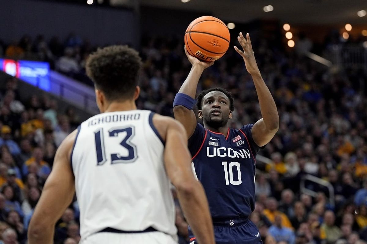 Mar 6, 2024; Milwaukee, Wisconsin, USA;  Connecticut Huskies guard Hassan Diarra (10) shoots during the first half against the Marquette Golden Eagles at Fiserv Forum.