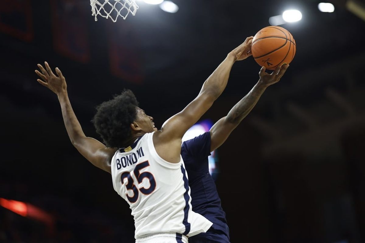 Dec 27, 2023; Charlottesville, Virginia, USA; Virginia Cavaliers guard Leon Bond III (35) blocks the shot of Morgan State Bears guard Rob Lawson (3) in the first half at John Paul Jones Arena.