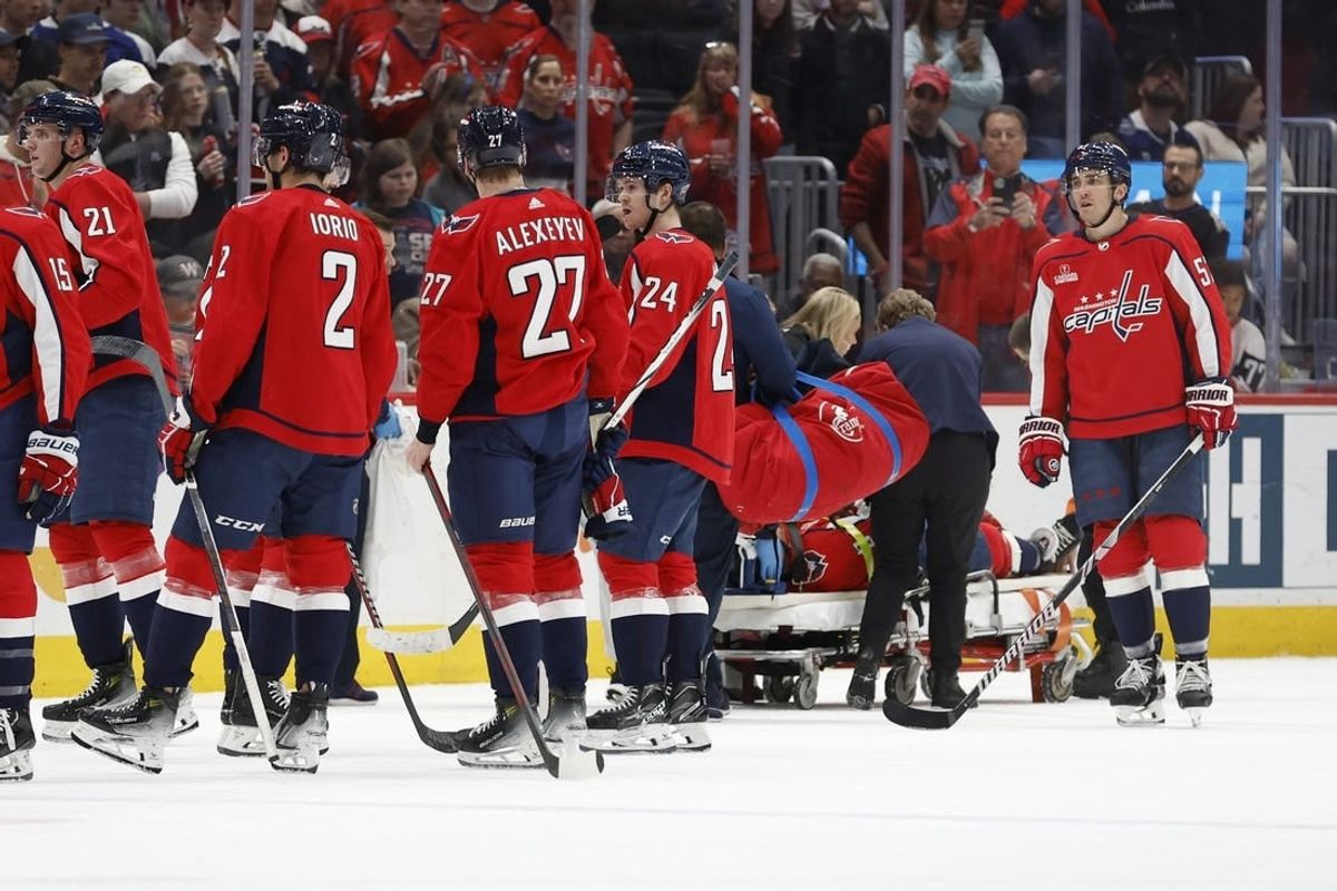 Apr 13, 2024; Washington, District of Columbia, USA; iIjured Washington Capitals defenseman Nick Jensen (3) is stretchered off the ice after a hit by Tampa Bay Lightning center Michael Eyssimont (not pictured) in the first period at Capital One Arena.