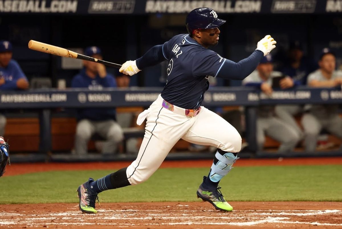 Apr 2, 2024; St. Petersburg, Florida, USA; Tampa Bay Rays first baseman Yandy Diaz (2) hits a RBI single during the third inning against the Texas Rangers at Tropicana Field.