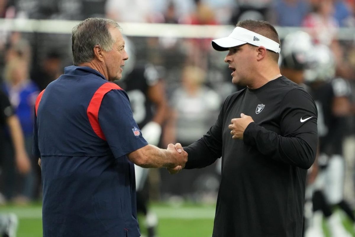 Aug 26, 2022; Paradise, Nevada, USA; New England Patriots head coach Bill Belichick (left) shakes hands with Las Vegas Raiders coach Josh McDaniels before the game at Allegiant Stadium.