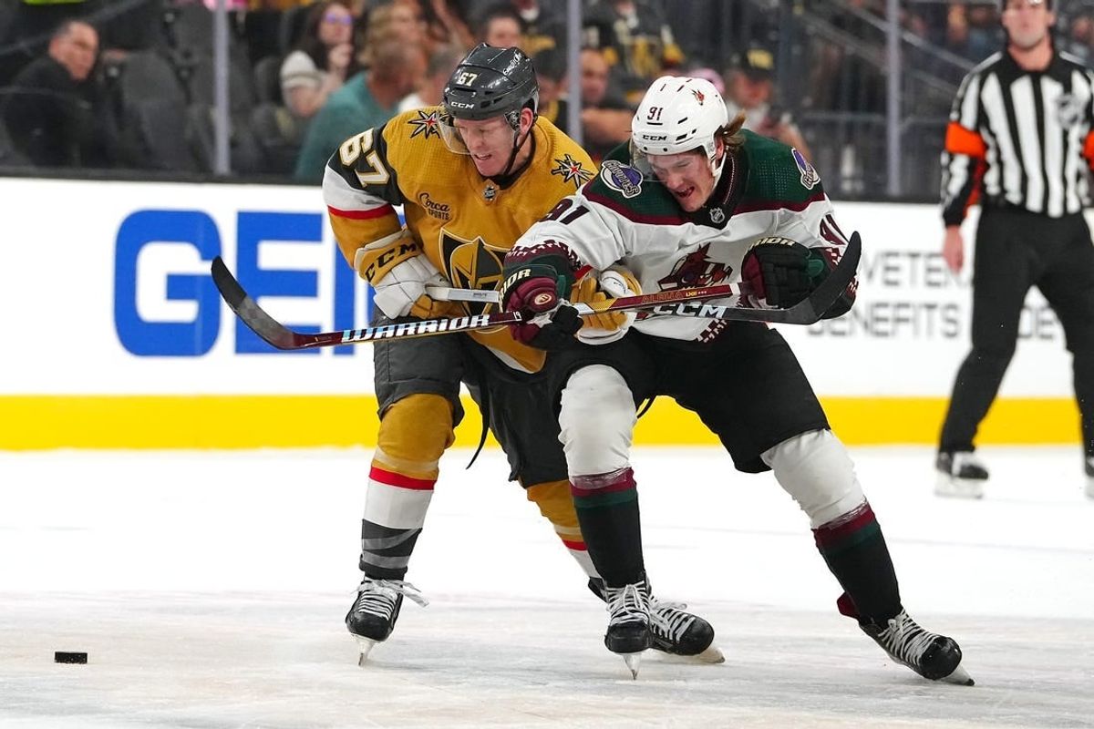 Sep 29, 2023; Las Vegas, Nevada, USA; Vegas Golden Knights left wing Tyler Benson (67) slows Arizona Coyotes right wing Josh Doan (91) during the first period at T-Mobile Arena.