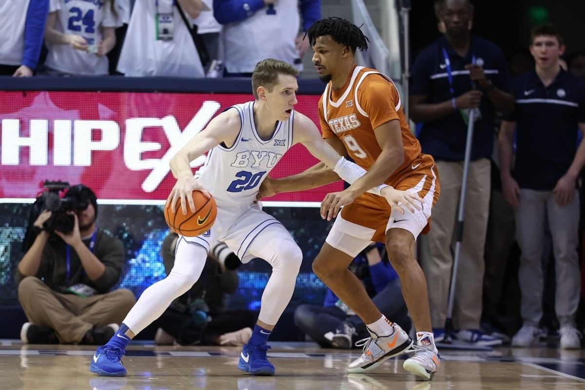 Jan 27, 2024; Provo, Utah, USA; Brigham Young Cougars guard Spencer Johnson (20) drives to the basket against Texas Longhorns guard Ithiel Horton (9) during the first half at Marriott Center.