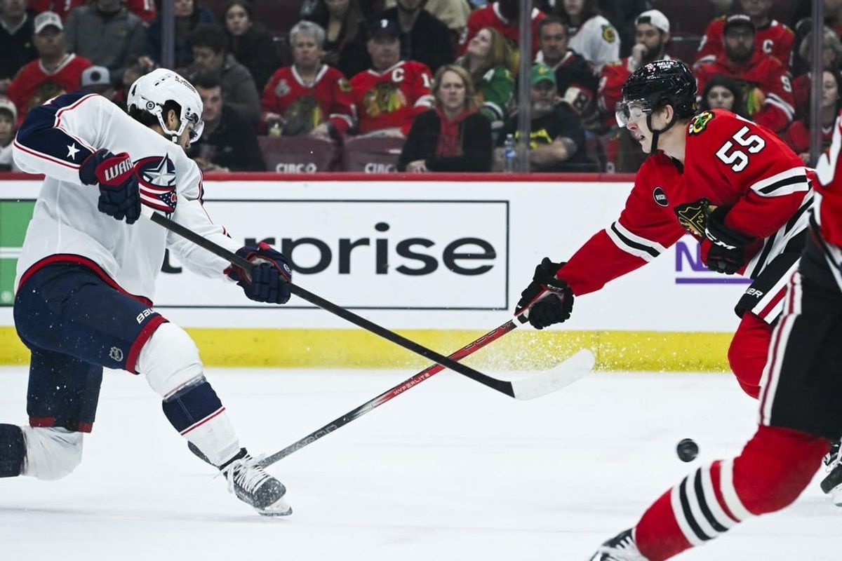 Mar 2, 2024; Chicago, Illinois, USA;  Columbus Blue Jackets center Cole Sillinger (4) shoots the puck against Chicago Blackhawks defenseman Kevin Korchinski (55) during the first period at the  United Center.