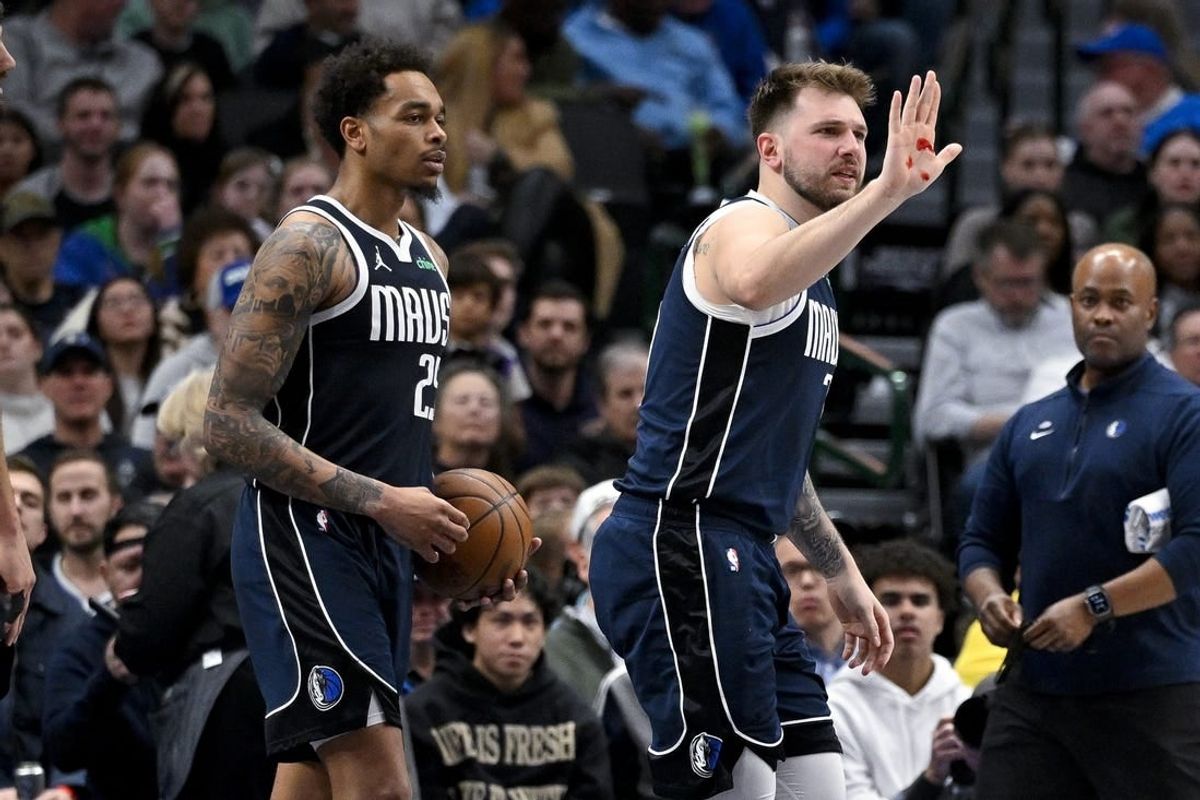 Feb 12, 2024; Dallas, Texas, USA; Dallas Mavericks guard Luka Doncic (77) shows blood on his hand after he is hit in the face by Washington Wizards forward Corey Kispert (not pictured) during the second half at the American Airlines Center.