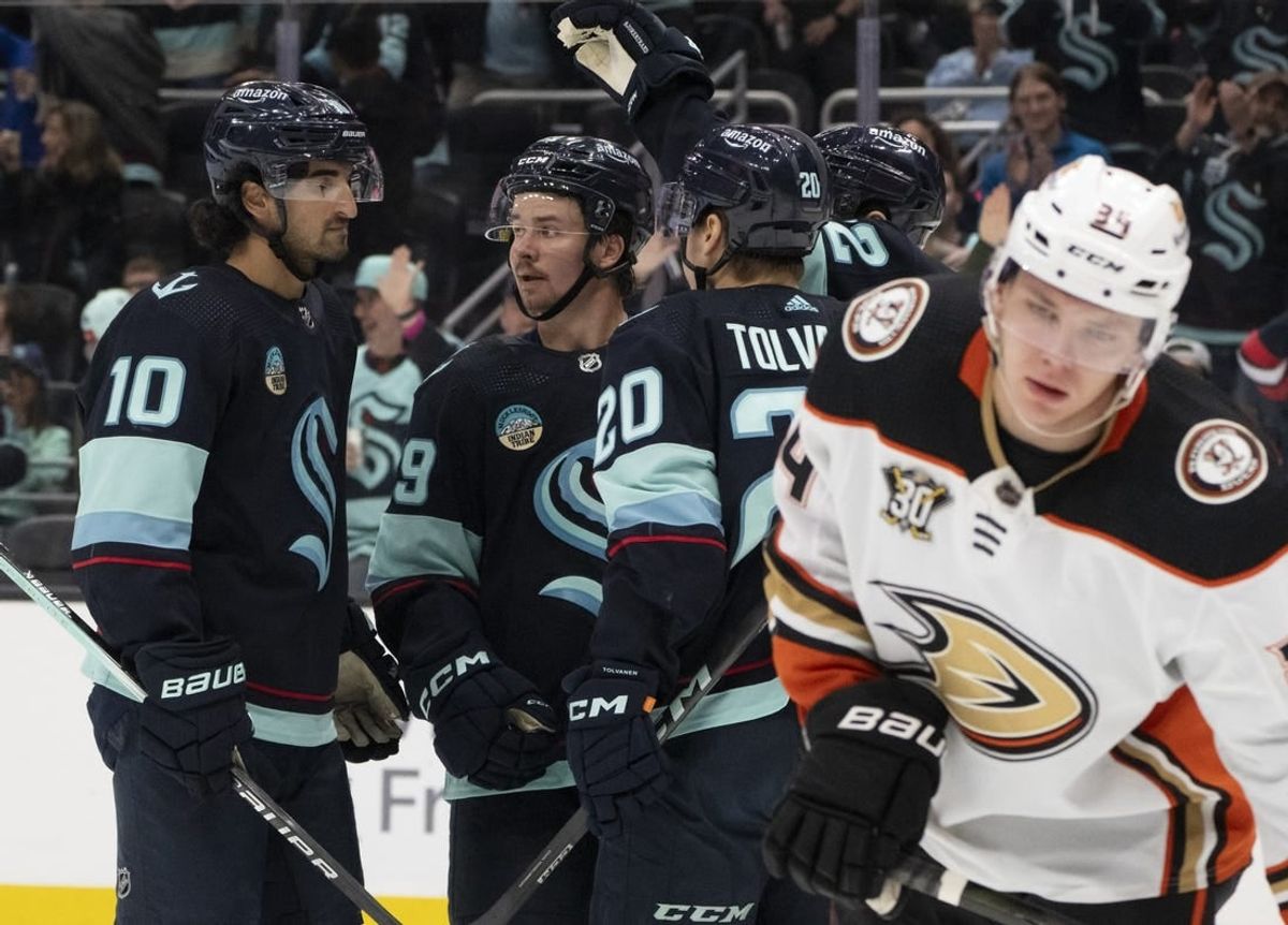 Mar 26, 2024; Seattle, Washington, USA; sSeattle Kraken players icnlduing forward Matty Beniers (10), forward Logan Morrison (59), second from left, and forward Eeli Tolvanen (20) celebrate a goald during the second period against the Anaheim Ducks gat Climate Pledge Arena.