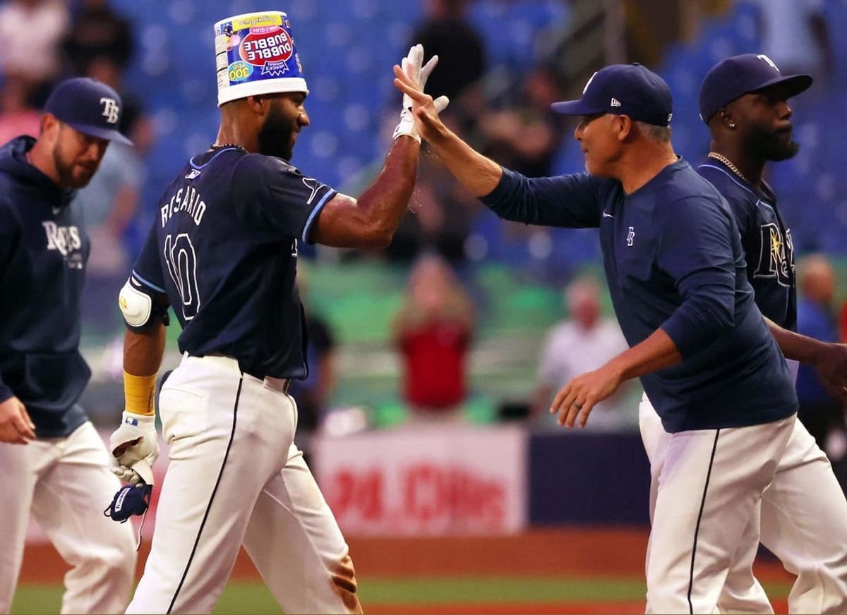 Apr 16, 2024; St. Petersburg, Florida, USA; Tampa Bay Rays outfielder Amed Rosario (10) is congratulated by  manager Kevin Cash (16) after hitting a walk off RBI double against the Los Angeles Angels at Tropicana Field.