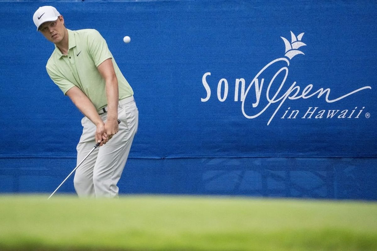 January 11, 2024; Honolulu, Hawaii, USA; Cam Davis hits his chip shot on the 17th hole during the first round of the Sony Open in Hawaii golf tournament at Waialae Country Club.