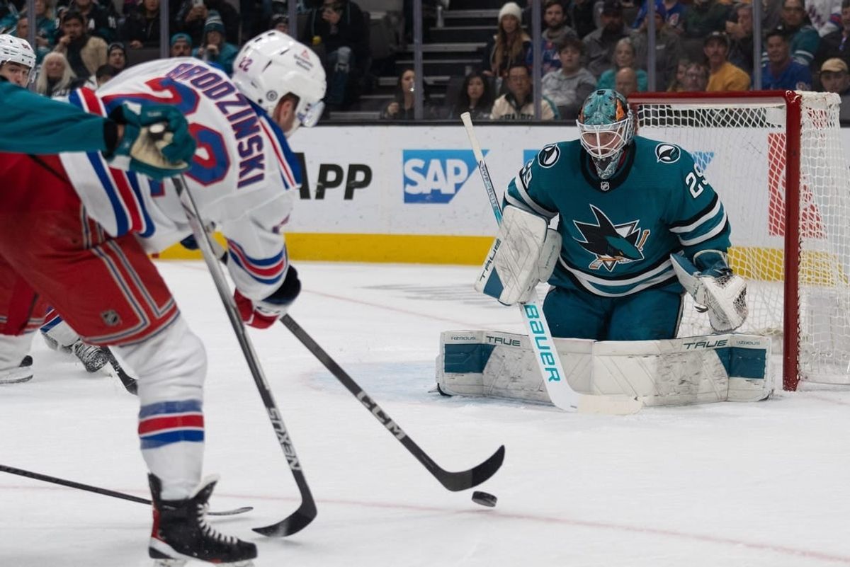 Jan 23, 2024; San Jose, California, USA; New York Rangers center Jonny Brodzinski (22) shoots the puck during the first period against San Jose Sharks goaltender Mackenzie Blackwood (29) at SAP Center at San Jose.