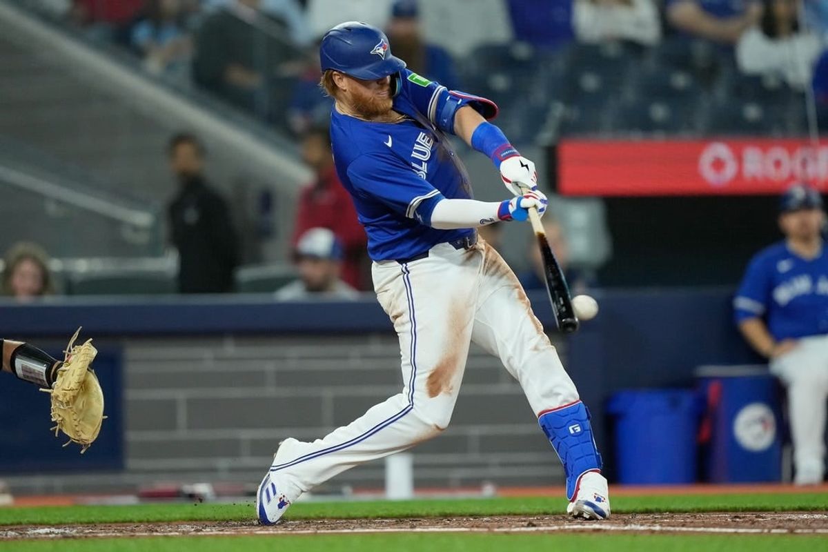 Apr 14, 2024; Toronto, Ontario, CAN; Toronto Blue Jays designated hitter Justin Turner (2) hits a one run double against the Colorado Rockies during the third inning at Rogers Centre.