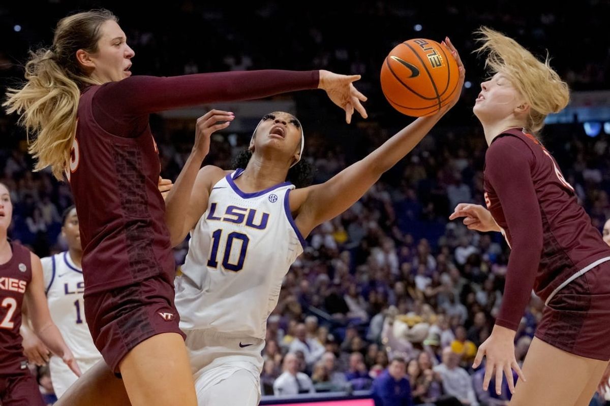 Nov 30, 2023; Baton Rouge, Louisiana, USA; Virginia Tech Hokies center Elizabeth Kitley (33) blocks the shot of LSU Lady Tigers forward Angel Reese (10) next Virginia Tech Hokies center Clara Strack (13) during the first half  at Pete Maravich Assembly Center.