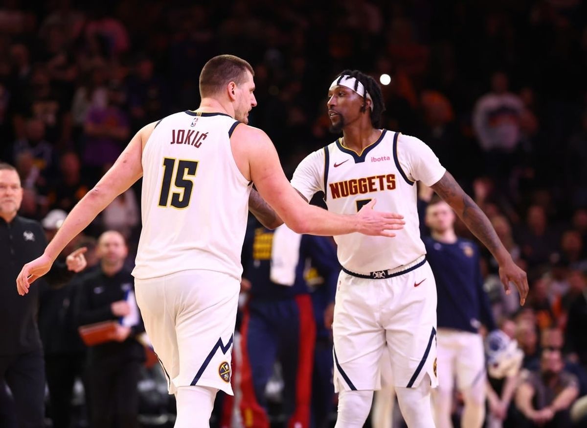 Dec 1, 2023; Phoenix, Arizona, USA; Denver Nuggets center Nikola Jokic (15) celebrates with guard Kentavious Caldwell-Pope (5) against the Phoenix Suns in the second half at Footprint Center.