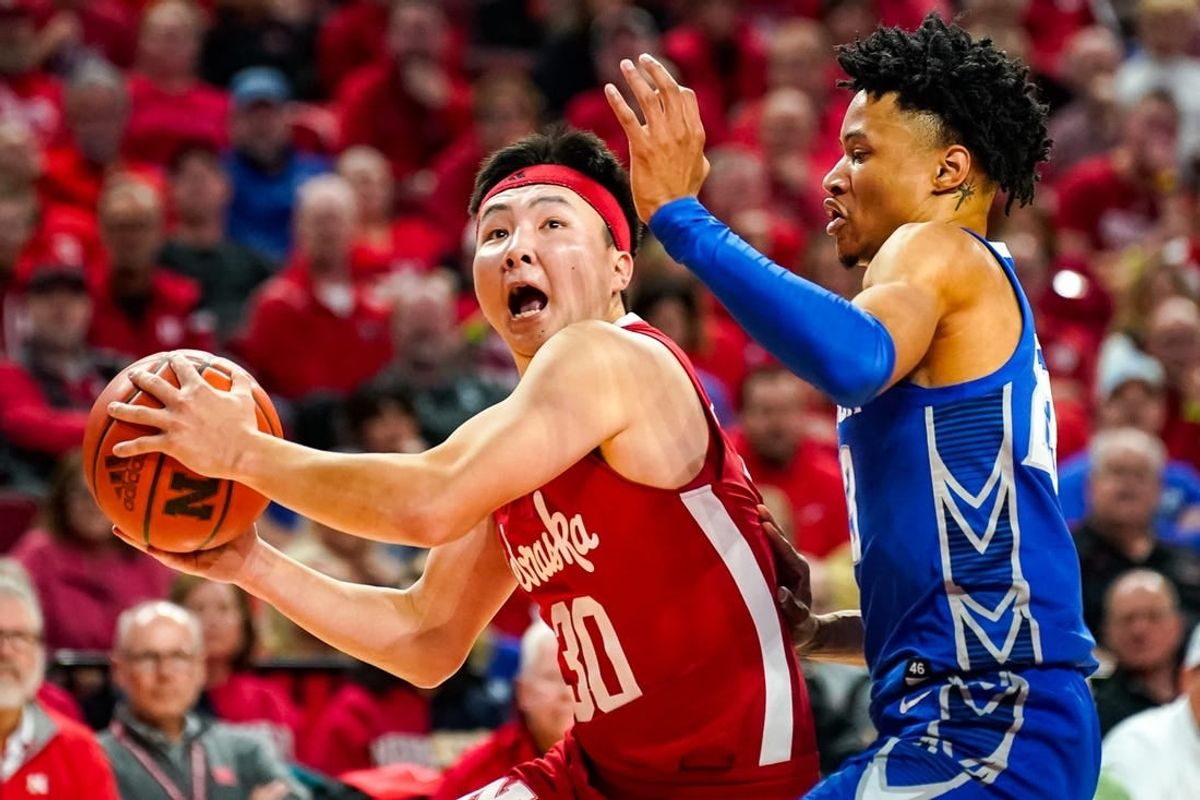 Dec 3, 2023; Lincoln, Nebraska, USA; Nebraska Cornhuskers guard Keisei Tominaga (30) drives to the hoop against Creighton Bluejays guard Trey Alexander (23) during the first half at Pinnacle Bank Arena.