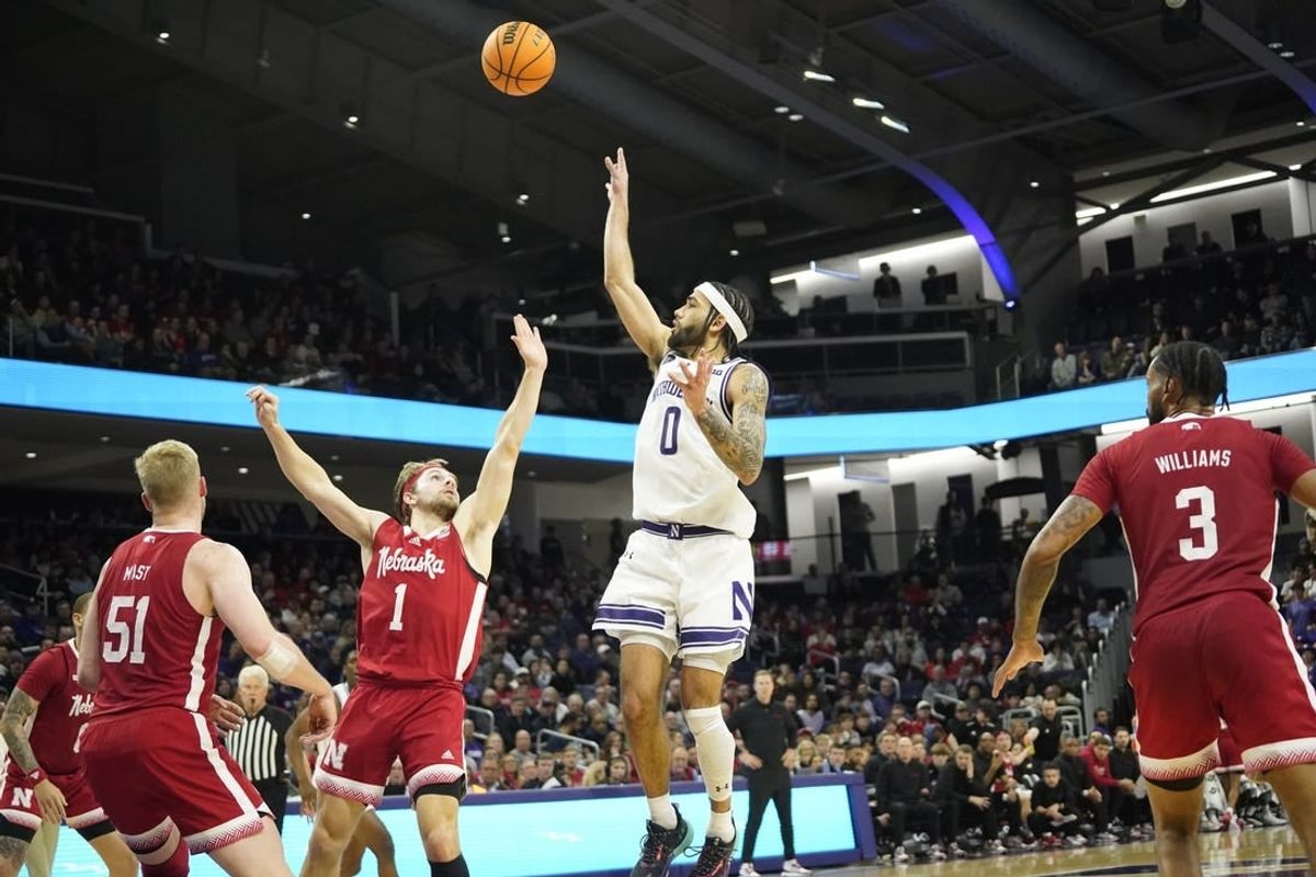 Feb 7, 2024; Evanston, Illinois, USA; Northwestern Wildcats guard Boo Buie (0) shoots over Nebraska Cornhuskers guard Sam Hoiberg (1) during the second half at Welsh-Ryan Arena.