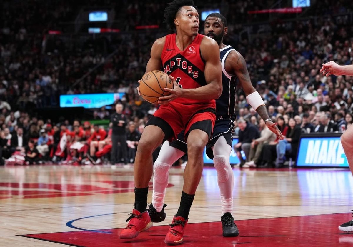 Feb 28, 2024; Toronto, Ontario, CAN; Toronto Raptors forward Scottie Barnes (4) controls the ball as Dallas Mavericks guard Kyrie Irving (11) tries to defend during the fourth quarter at Scotiabank Arena.
