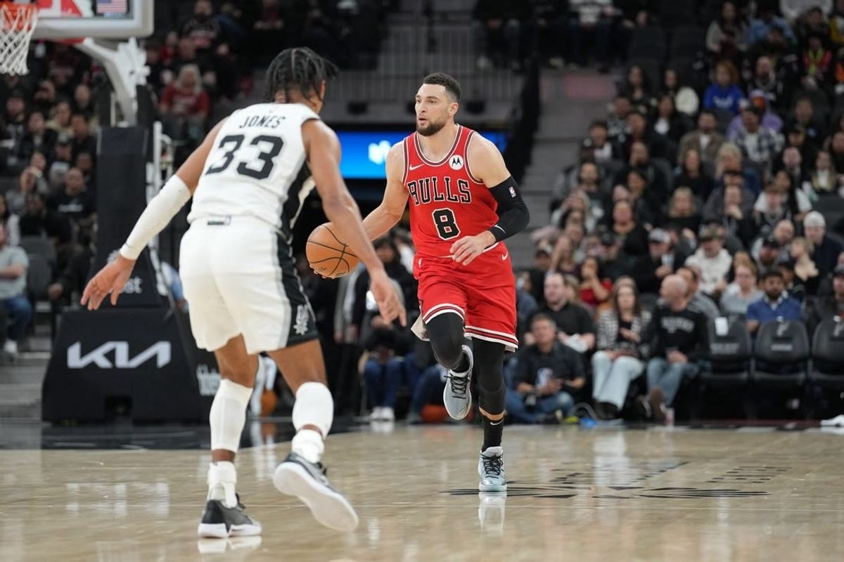 Jan 13, 2024; San Antonio, Texas, USA;  Chicago Bulls guard Zach LaVine (8) dribbles in front of San Antonio Spurs guard Tre Jones (33) in the first half at Frost Bank Center.