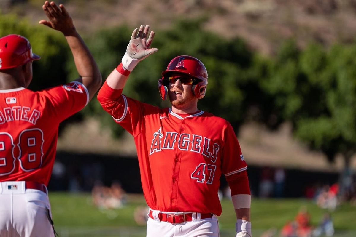 Mar 8, 2024; Tempe, Arizona, USA; Los Angeles Angels infielder Sam Brown (47) celebrates after hitting the go ahead run in the ninth to score outfielder Jordyn Adams (39) (not shown) in the ninth during a spring training game against the Colorado Rockies at Tempe Diablo Stadium.