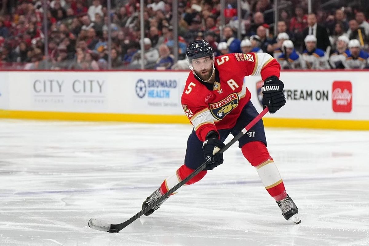 Dec 21, 2023; Sunrise, Florida, USA; Florida Panthers defenseman Aaron Ekblad (5) passes the puck against the St. Louis Blues during the second period at Amerant Bank Arena.
