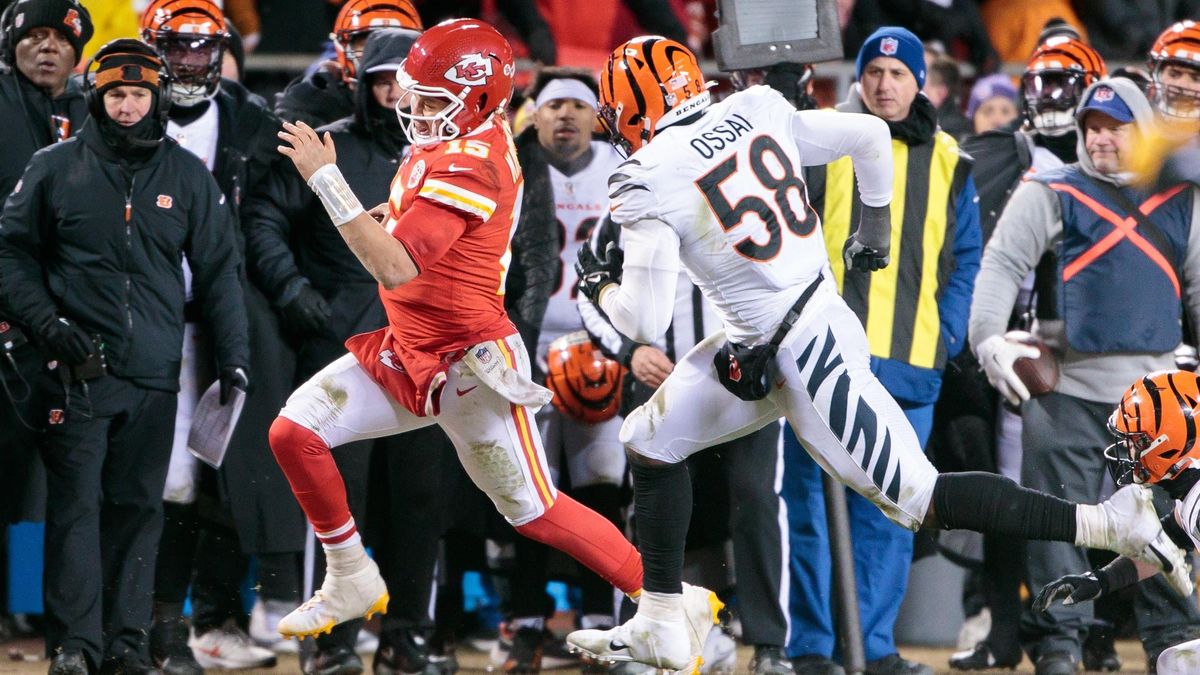 Kansas City Chiefs quarterback Patrick Mahomes heads out of bounds in front of Cincinnati Bengals’ defensive end Joseph Ossai during the last second of the game on Jan.  29 , 2023,  at Arrowhead Stadium.