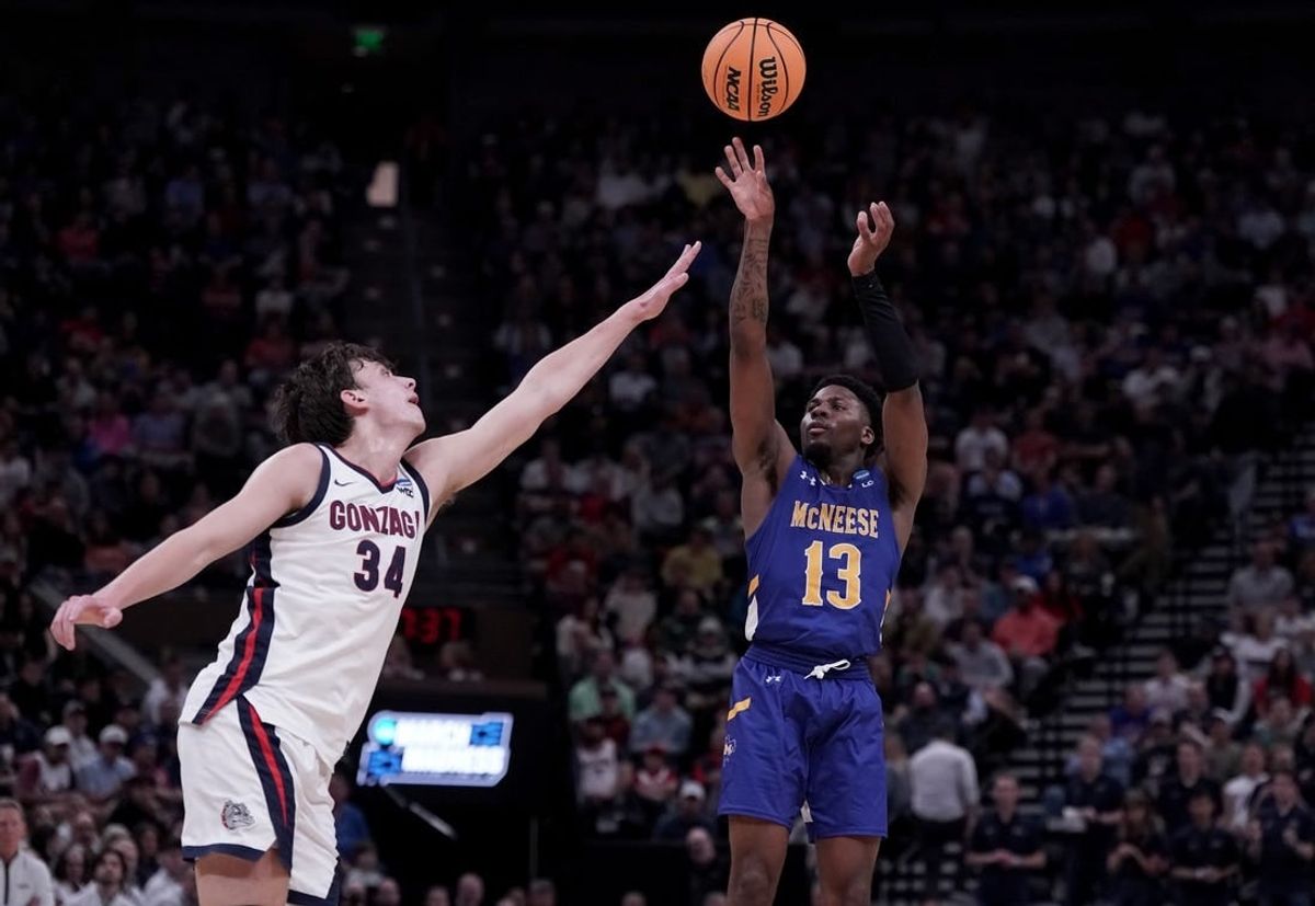 Mar 21, 2024; Salt Lake City, UT, USA; McNeese State Cowboys guard Shahada Wells (13) shoots against Gonzaga Bulldogs forward Braden Huff (34) during the second half in the first round of the 2024 NCAA Tournament at Vivint Smart Home Arena-Delta Center.