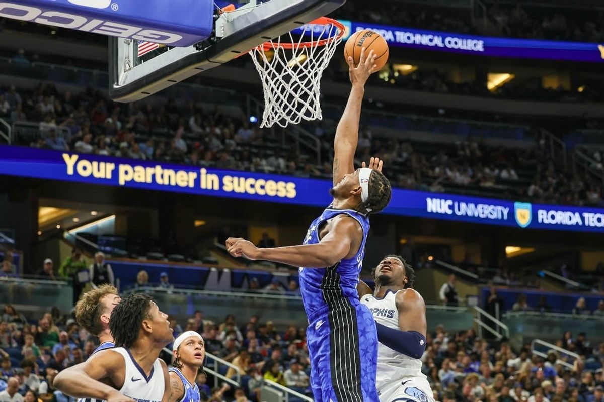 Mar 30, 2024; Orlando, Florida, USA; Orlando Magic center Wendell Carter Jr. (34) blocks a shot attempt by Memphis Grizzlies forward Jaren Jackson Jr. (13) during the second half at KIA Center.