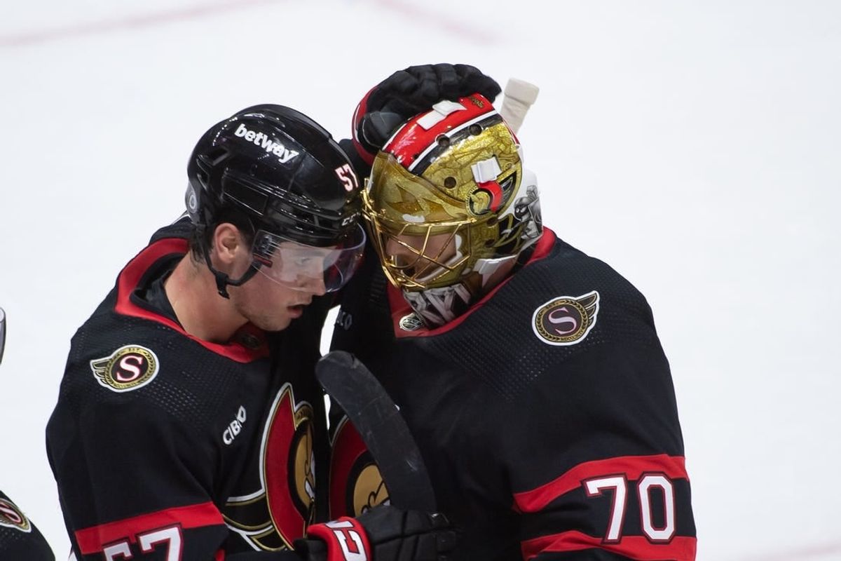 Feb 10, 2024; Ottawa, Ontario, CAN; Ottawa Senators center Shane Pinto (57) celebrates with goalie Joonas Korpisalo (70) their win against the Toronto Maple Leafs at the Canadian Tire Centre.