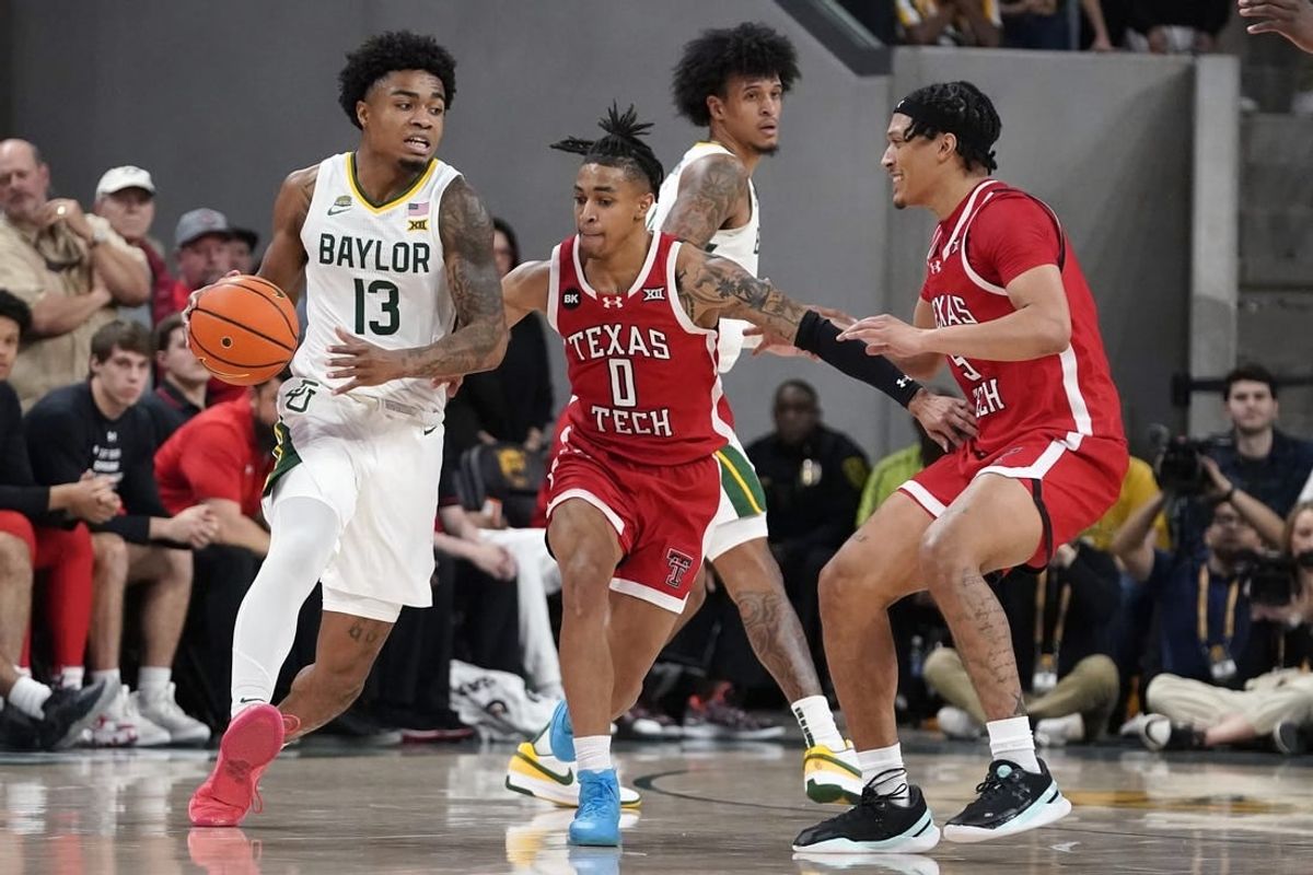 Feb 6, 2024; Waco, Texas, USA; Baylor Bears guard Langston Love (13) dribbles around Texas Tech Red Raiders guard Chance McMillian (0) during the first half at Paul and Alejandra Foster Pavilion.