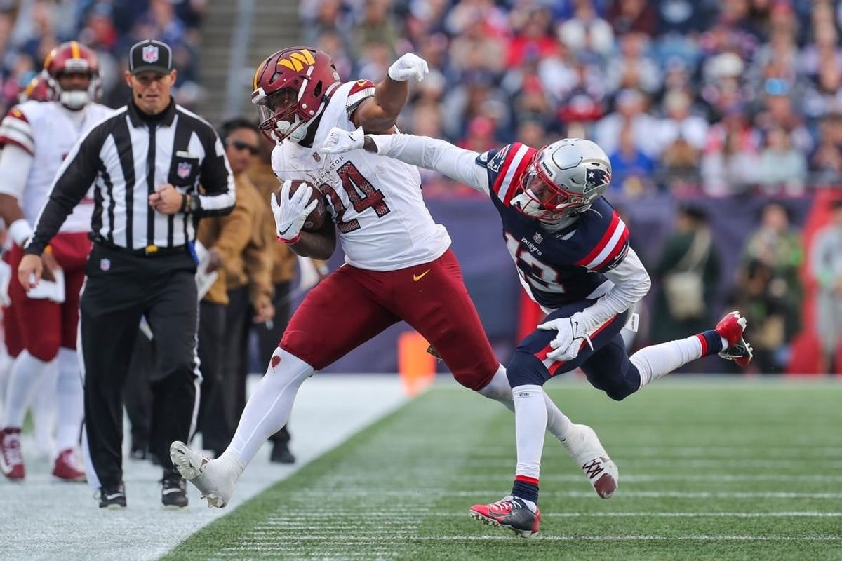 Nov 5, 2023; Foxborough, Massachusetts, USA; New England Patriots cornerback Jack Jones (13) pushes Washington Commanders running back Antonio Gibson (24) out of bounds during the second half at Gillette Stadium.