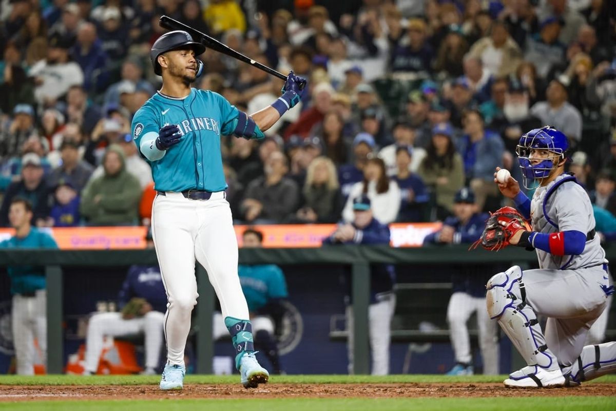 Apr 13, 2024; Seattle, Washington, USA; Seattle Mariners center fielder Julio Rodriguez (44) strikes out to end the seventh inning at T-Mobile Park. Chicago Cubs catcher Miguel Amaya (9) reacts at right.