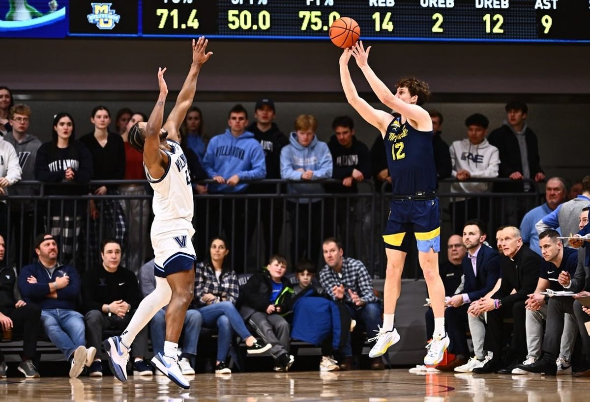Jan 30, 2024; Villanova, Pennsylvania, USA; Marquette Golden Eagles forward Ben Gold (12) shoots against Villanova Wildcats forward Eric Dixon (43) in the first half at William B. Finneran Pavilion.