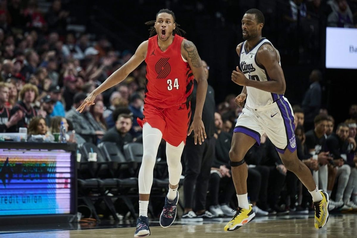 Dec 26, 2023; Portland, Oregon, USA; Portland Trail Blazers forward Jabari Walker (34) celebrates making a three point basket during the second half against Sacramento Kings forward Harrison Barnes (40) at Moda Center.