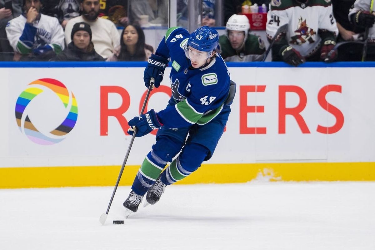 Jan 18, 2024; Vancouver, British Columbia, CAN; Vancouver Canucks defenseman Quinn Hughes (43) handles the puck against the Arizona Coyotes in the third period at Rogers Arena. Vancouver won 2-1.