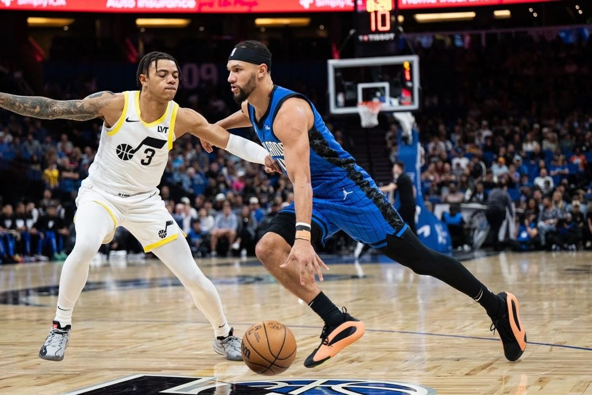 Feb 29, 2024; Orlando, Florida, USA; Orlando Magic guard Jalen Suggs (4) dribbles the ball against Utah Jazz guard Keyonte George (3) in the first quarter at Kia Center.