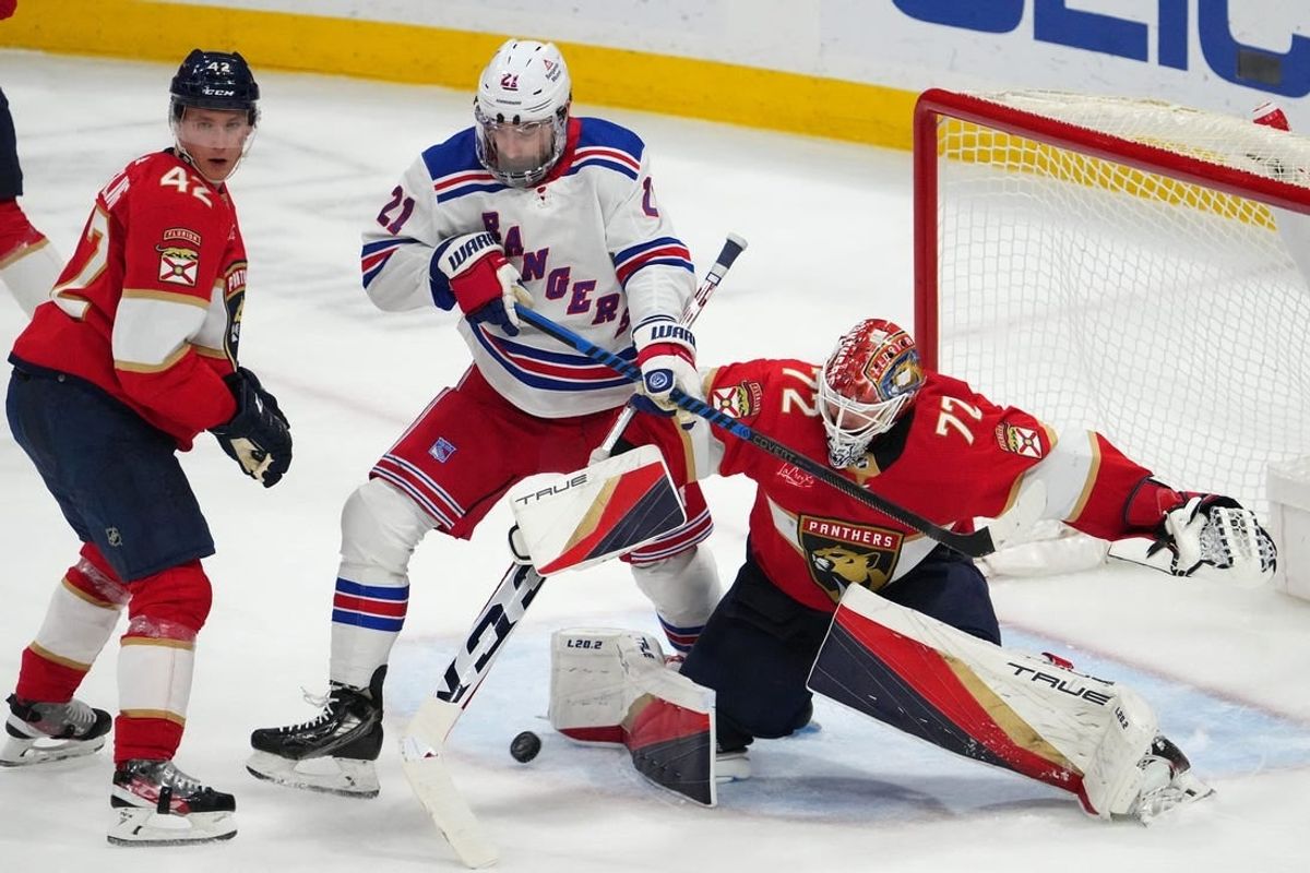 Dec 29, 2023; Sunrise, Florida, USA; Florida Panthers goaltender Sergei Bobrovsky (72) stops a shot behind New York Rangers center Barclay Goodrow (21) during the third period at Amerant Bank Arena.