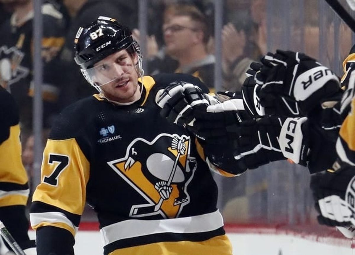 Jan 2, 2024; Pittsburgh, Pennsylvania, USA;  Pittsburgh Penguins center Sidney Crosby (87) celebrates with the Pens bench after scoring a power play goal against the Washington Capitals during the second period at PPG Paints Arena.