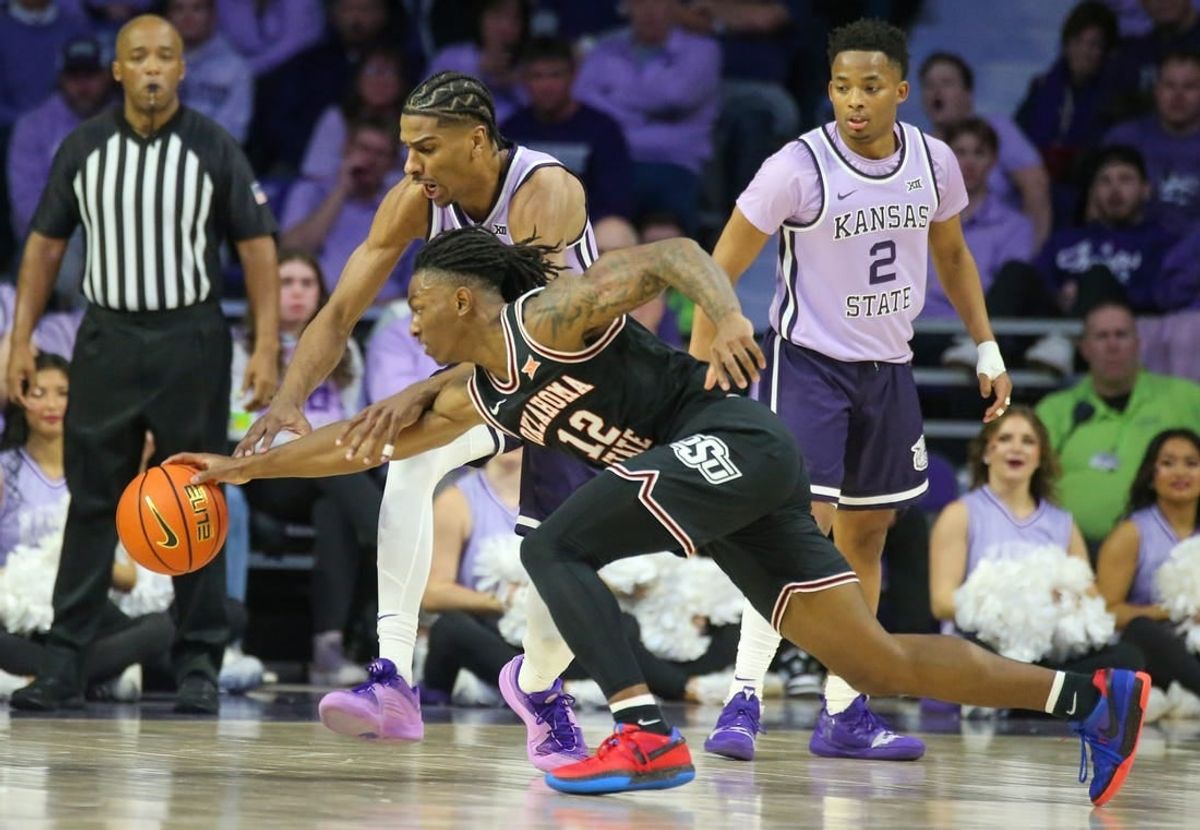 Jan 20, 2024; Manhattan, Kansas, USA; Oklahoma State Cowboys guard Javon Small (12) and Kansas State Wildcats forward David N'Guessan (1) go after a loose ball during the first half at Bramlage Coliseum.