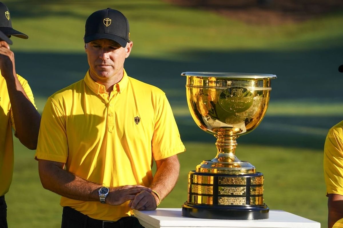 Sep 21, 2022; Charlotte, North Carolina, USA; International Team captain Trevor Immelman stands next to the trophy during a practice day for the Presidents Cup golf tournament at Quail Hollow Club.