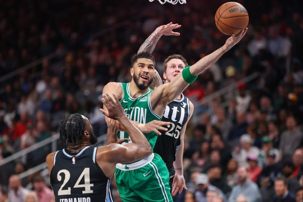 Mar 25, 2024; Atlanta, Georgia, USA; Boston Celtics forward Jayson Tatum (0) shoots past Atlanta Hawks forward Bruno Fernando (24) and guard Garrison Mathews (25) in the second quarter at State Farm Arena.