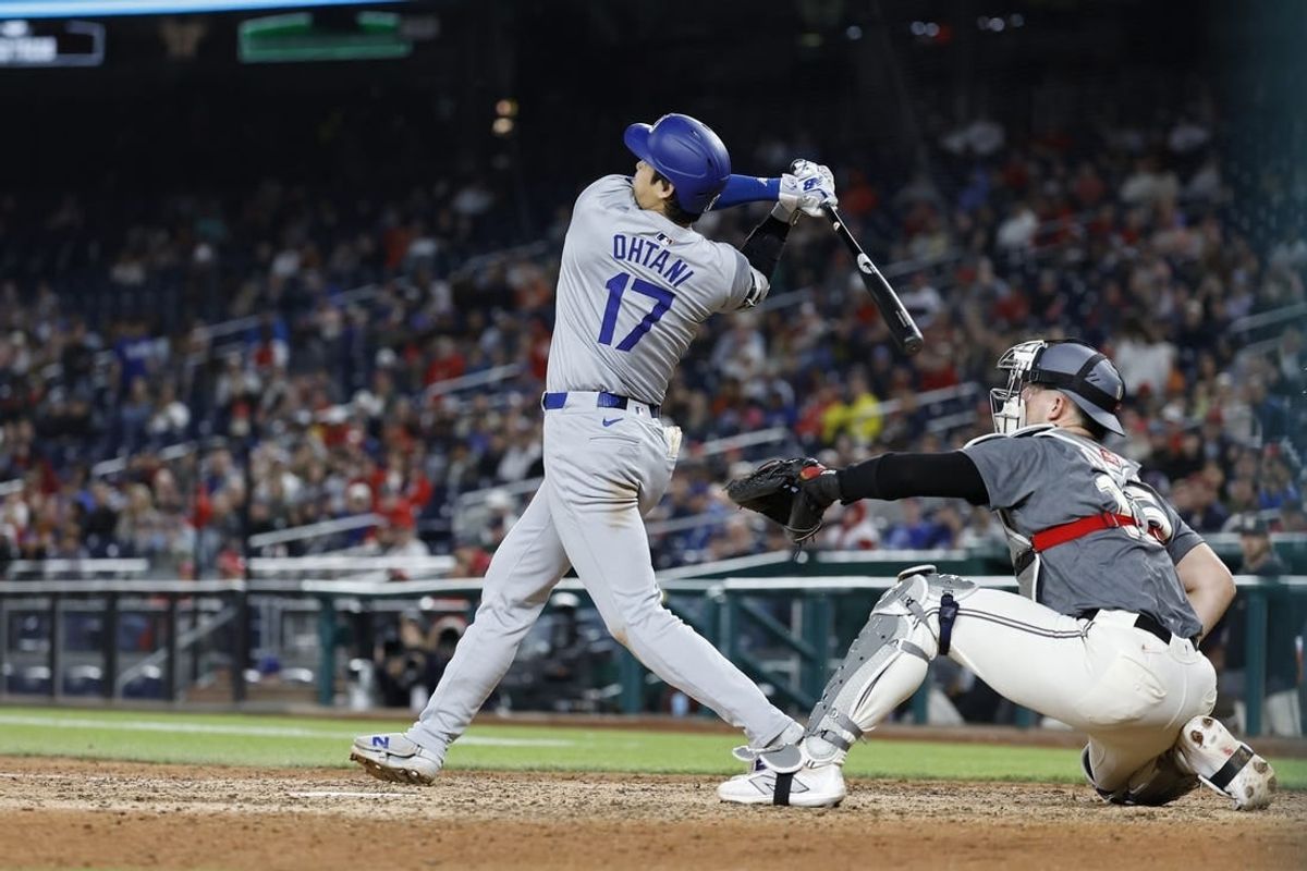 Apr 23, 2024; Washington, District of Columbia, USA; Los Angeles Dodgers designated hitter Shohei Ohtani (17) hits a solo home run against the Washington Nationals during the ninth inning at Nationals Park.