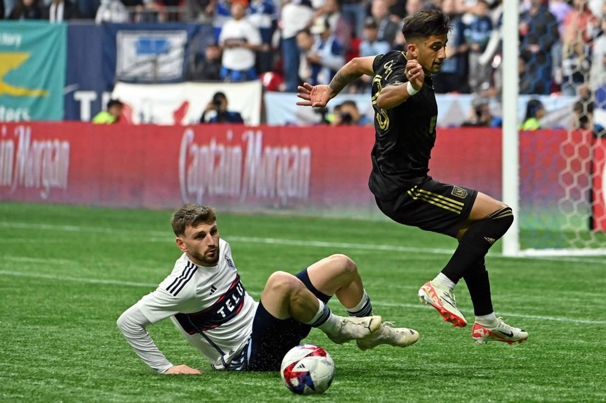 Nov 5, 2023; Vancouver, British Columbia, CAN; Vancouver Whitecaps defender Tristan Blackmon (6) tackles the ball away from Los Angeles FC forward Cristian Olivera (25) during the second half of game two in a round one match of the 2023 MLS Cup Playoffs at BC Place.